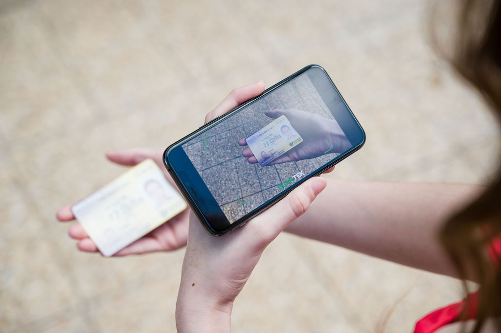 woman scans her ID with a smartphone app